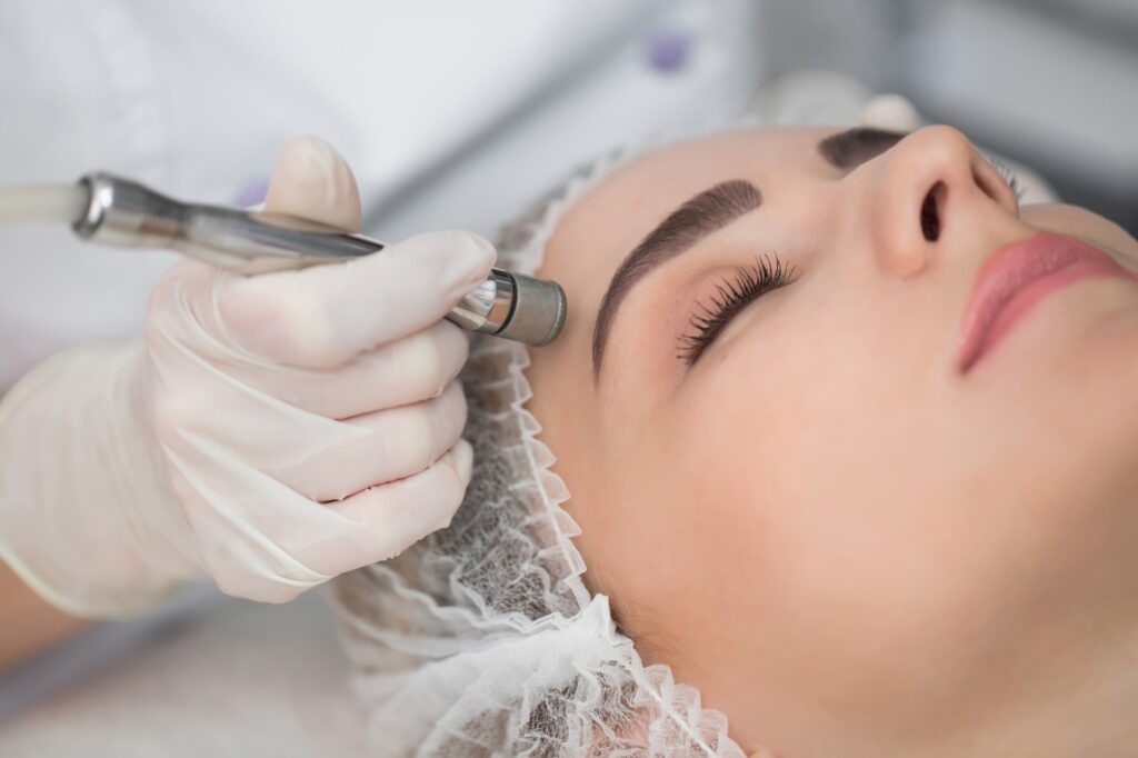 Diamond microdermabrasion. Woman during a microdermabrasion treatment in beauty salon