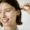 Woman Smiling Widely While Using Face Serum