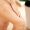Beautiful young woman applying body scrub on leg at home