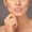 Closeup studio shot of a woman with gorgeous glossy lips against a gray background