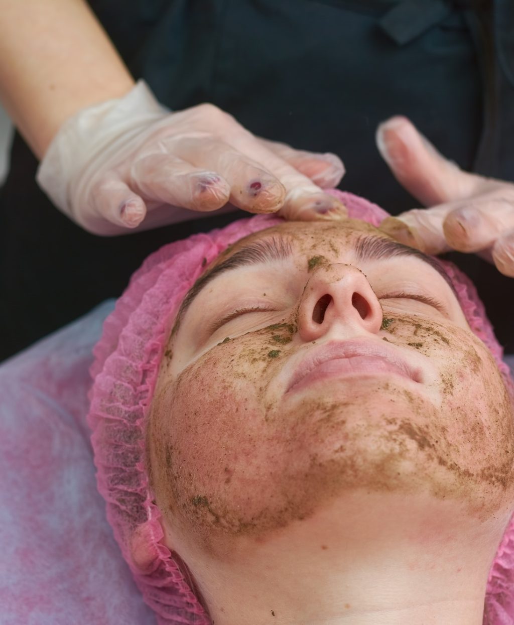 Coral face peel, young woman