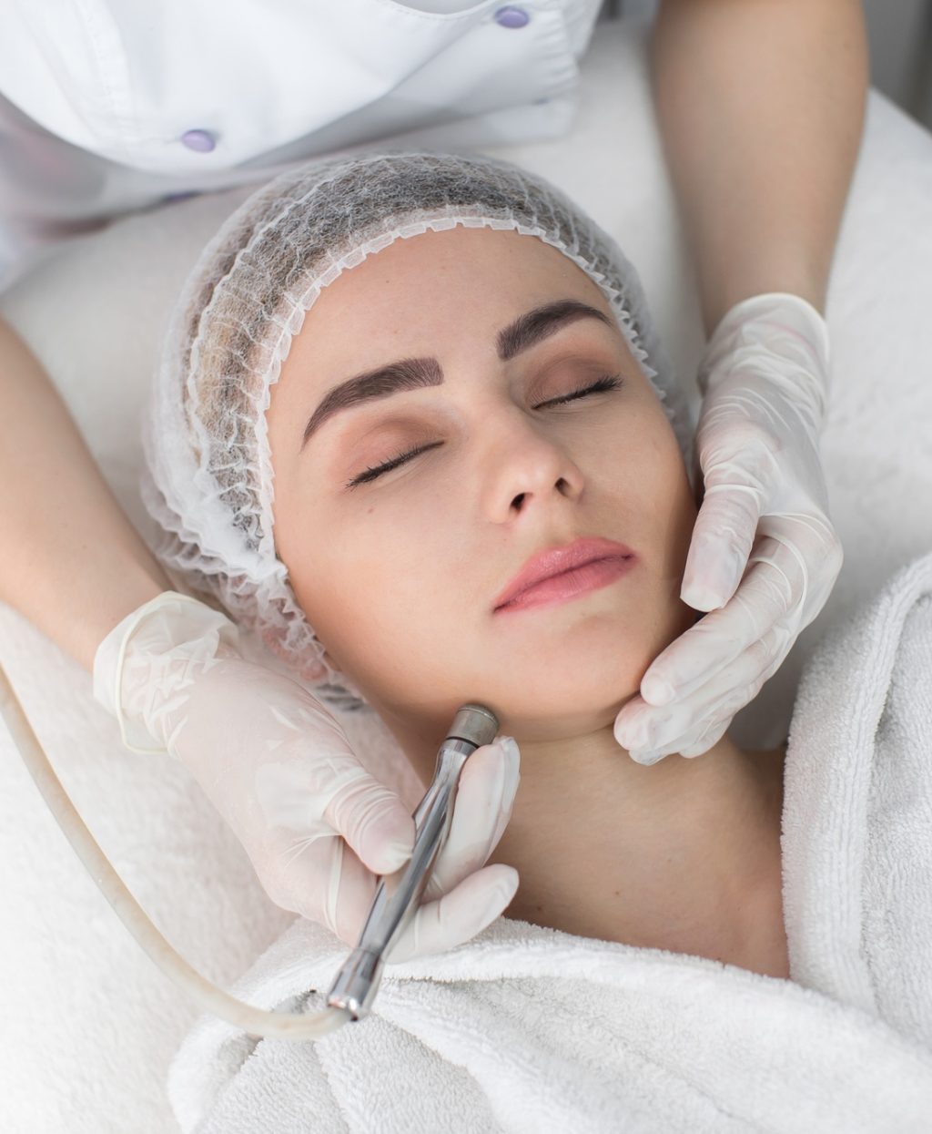 Diamond microdermabrasion. Woman during a microdermabrasion treatment in beauty salon